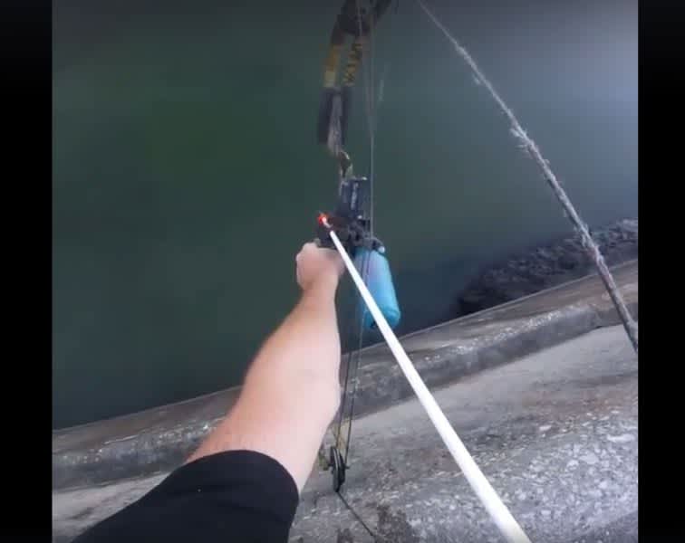 Video: Long Distance Bowfishing From the Top of a Dam