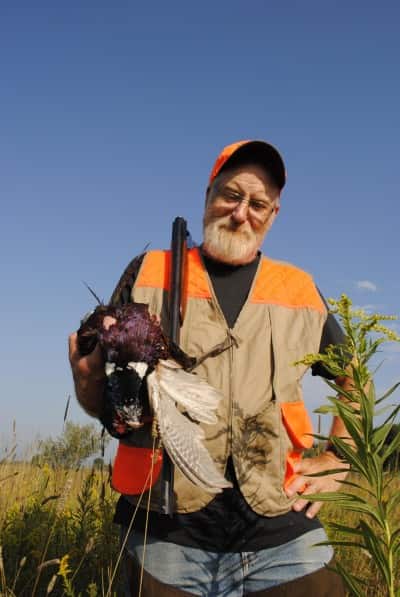 Tim Somerville shows off a rooster.
