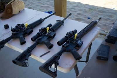 The Media Day range at the Crimson Trace Midnight 3 Gun Invitational displayed especially good manners. Note all guns pointed down range, tables with chambers open and chamber flags in place.