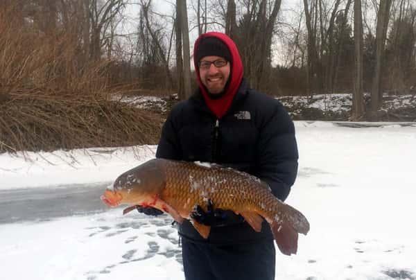 Andrew Plumridge with his massive carp. Image courtesy Andrew Plumridge.