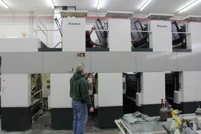 The author checks on the printing of his latest book. He has self-published a dozen books in the past 20 years.