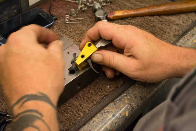 Trigger groups are assembled by hand, then packed in egg crates to await the testing phase.