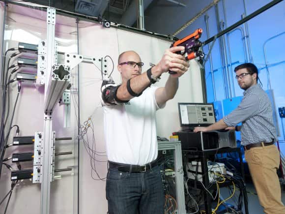 This prototype arm brace works using cables and motors to correct shaking while shooting a handgun.