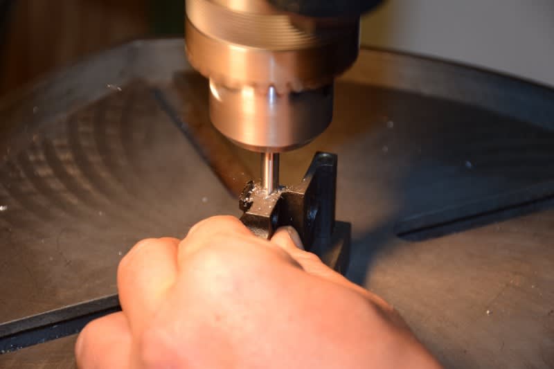 Chamfering the rear trunnion's rivet holes.