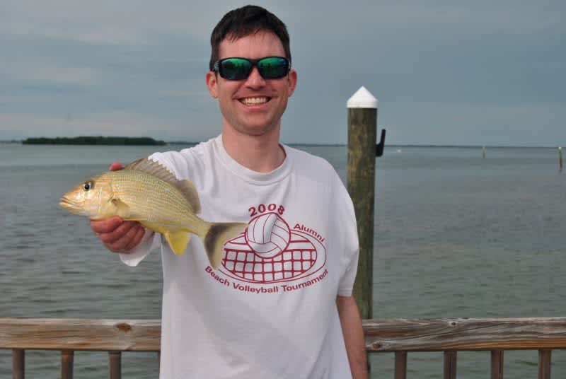 The author with a snapper caught from shore.