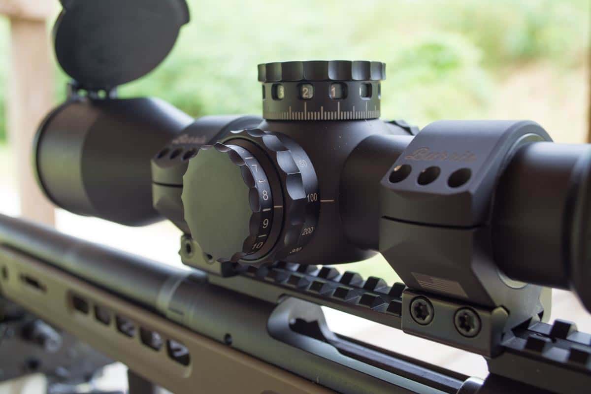 The inner wheel on the left side adjusts for parallax while the outer dial controls reticle illumination.